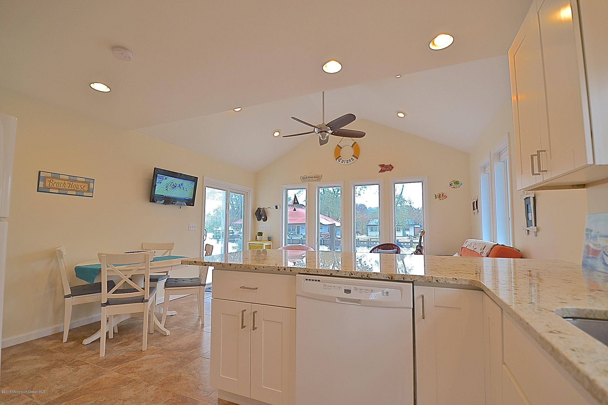 45 North Island Road Bayville, NJ 08721 - Photo 5 of 31 a very nice looking dining room with kitchen island granite countertop a table chairs sink and cabinets