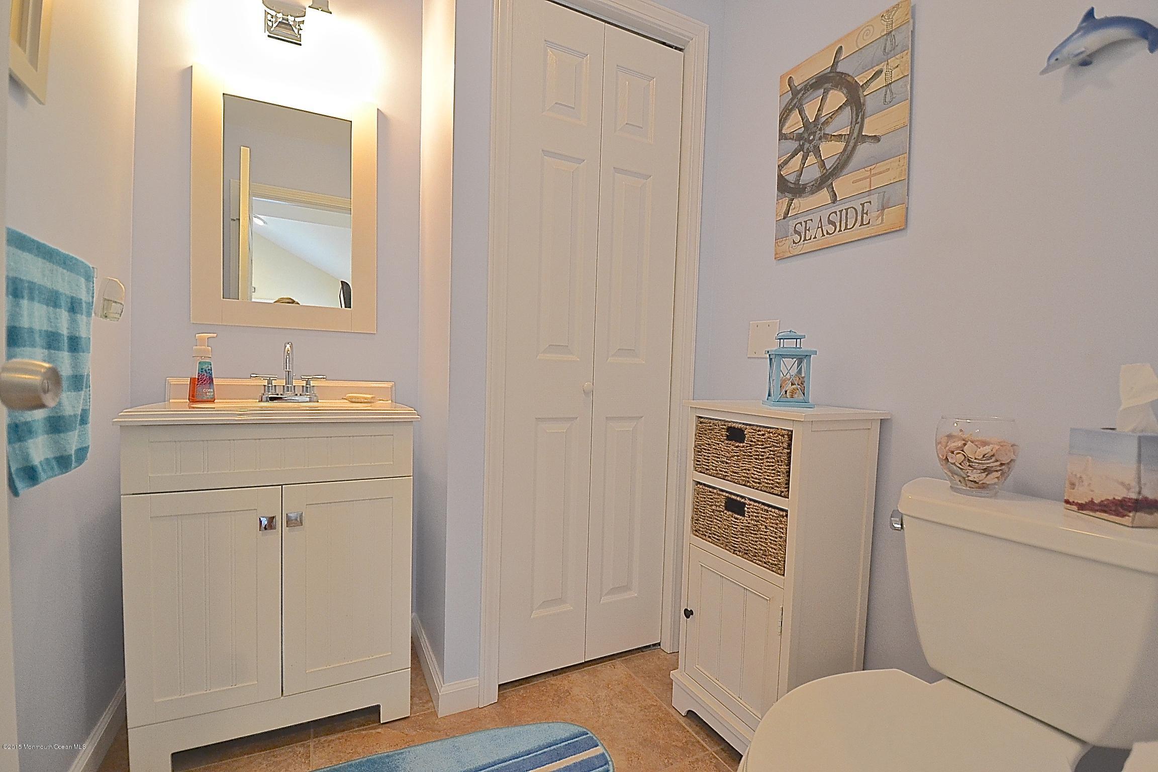45 North Island Road Bayville, NJ 08721 - Photo 10 of 31 a bathroom with a toilet sink and mirror