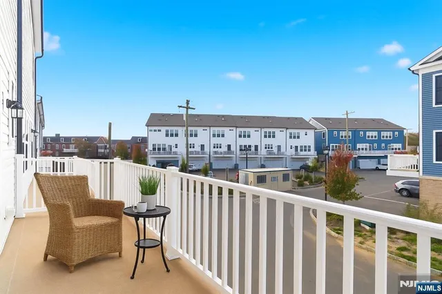 a view of a balcony with two chairs and a table