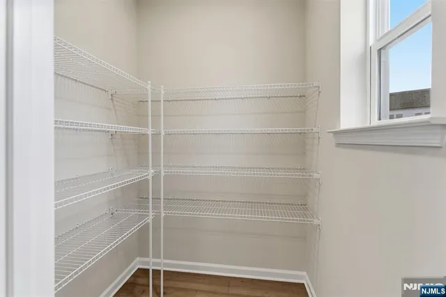 a view of walk in closet with empty racks