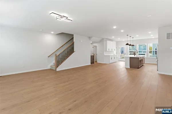 a view of a kitchen with furniture and wooden floor
