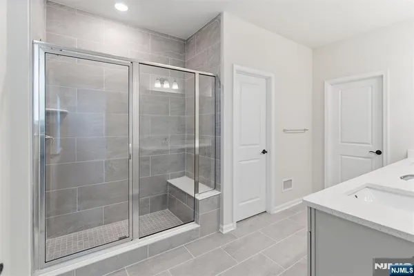 a bathroom with a shower and a sink