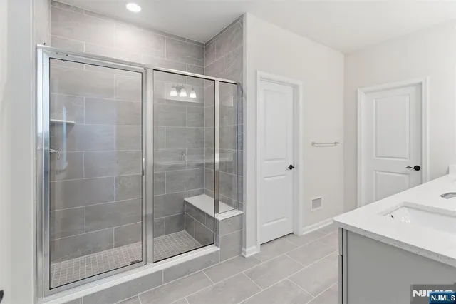 a bathroom with a shower and a sink