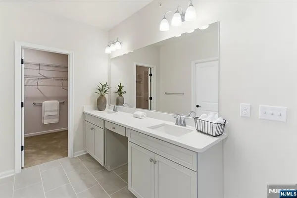 a bathroom with a sink vanity and a mirror