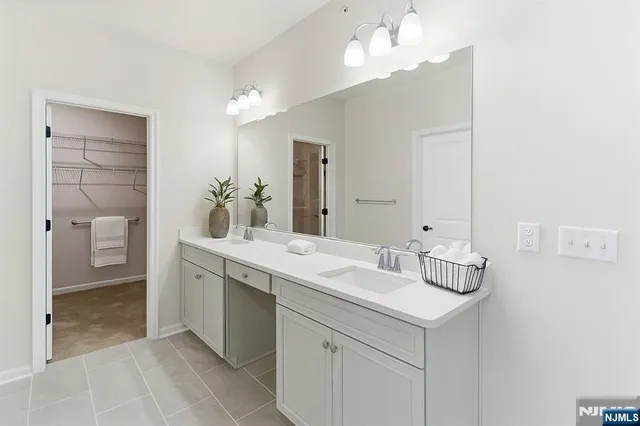 a bathroom with a sink vanity and a mirror