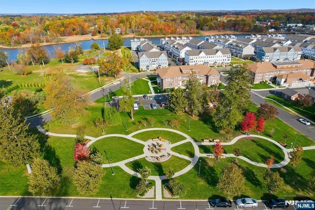an aerial view of a residential houses with outdoor space