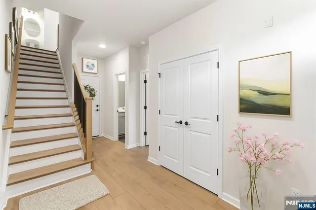 a view of a hallway with wooden floor and entryway