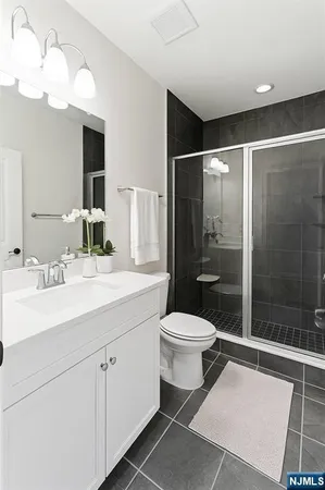 a bathroom with a toilet sink and shower