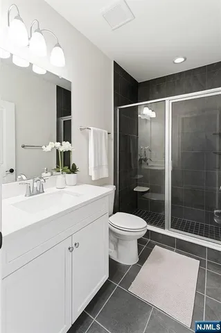 a bathroom with a toilet sink and shower