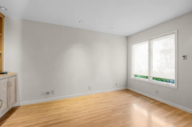 a bathroom with a granite countertop sink and a large mirror