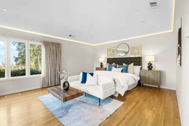 a view of patio with table and chairs and potted plants with wooden floor and fence