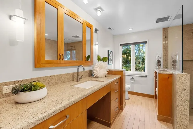 a front view of a house with lots of green space