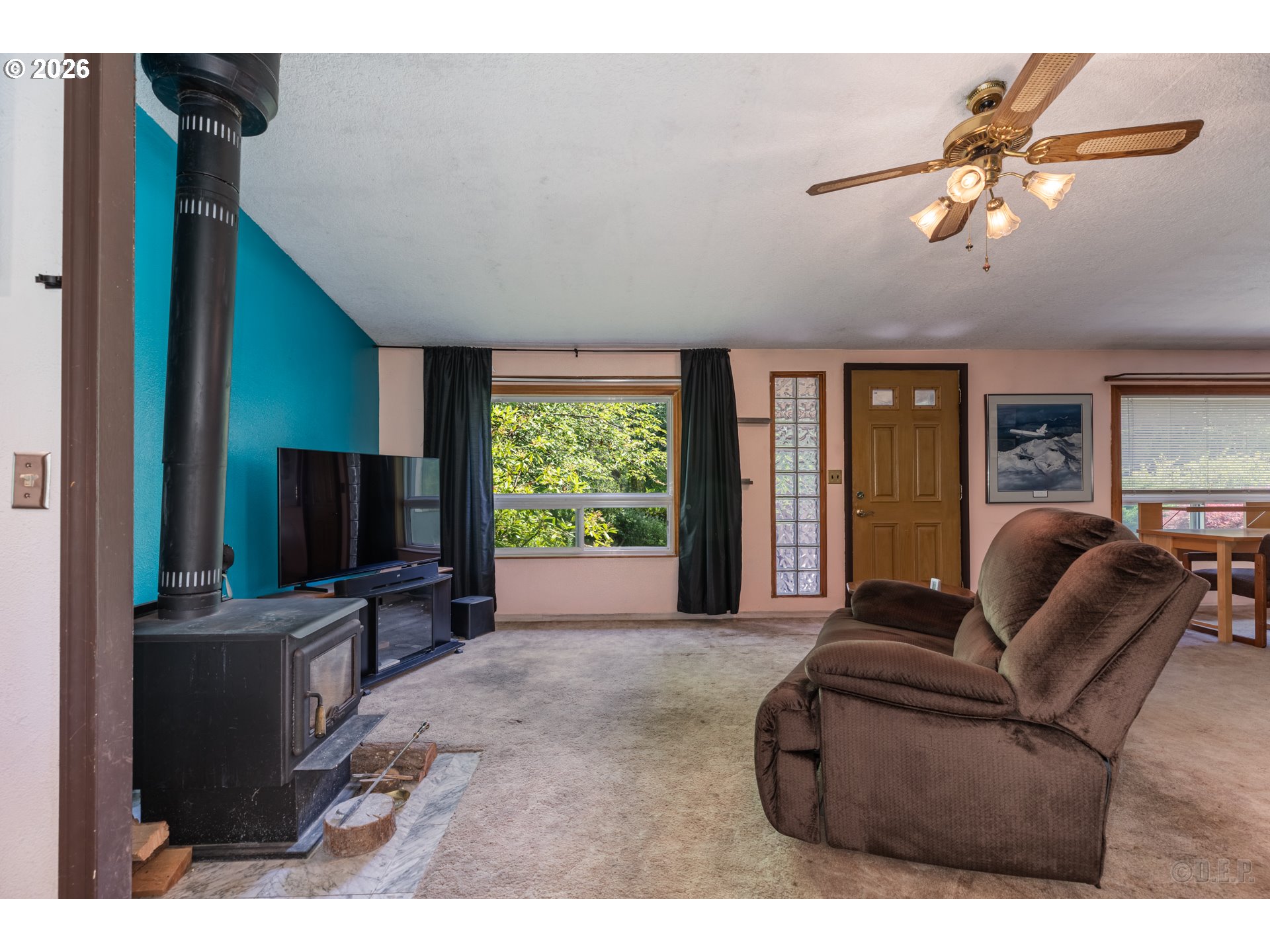 66971 Maplecrest Road Deer Island, OR 97054 - Photo 6 of 24 a living room with furniture and a flat screen tv