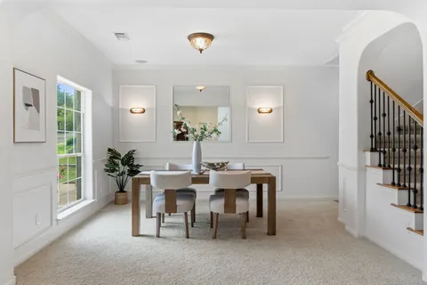 a kitchen with a dining table chairs and microwave