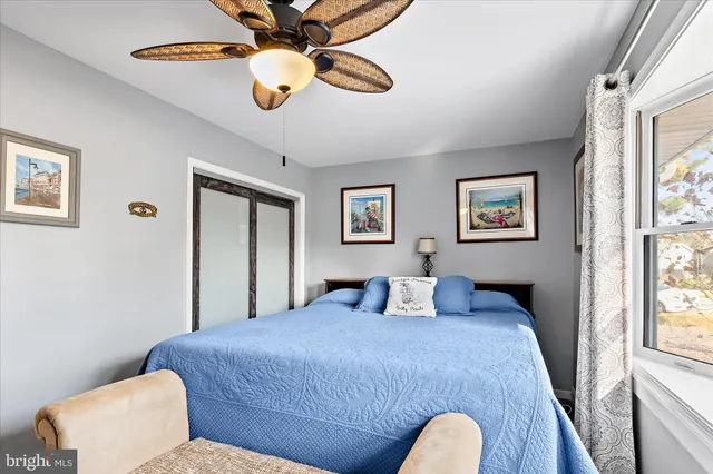 a bedroom with a large bed and a window