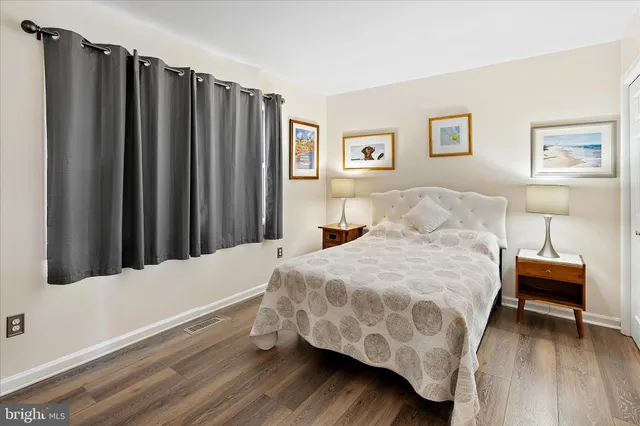 a very nice looking room with a large window and a wooden floor