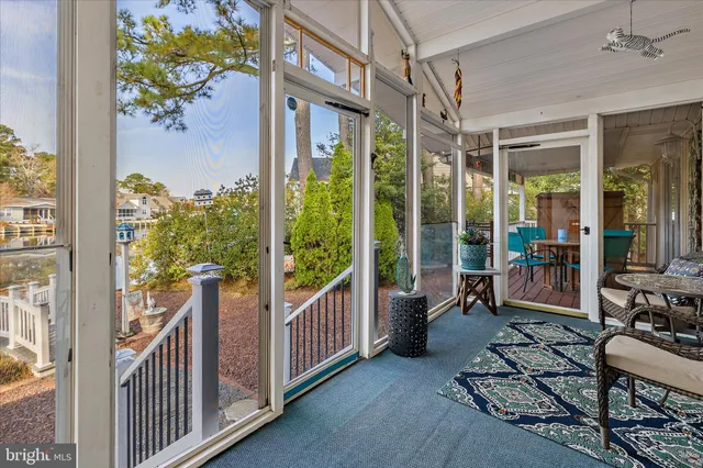 a view of a hallway with wooden floor and windows