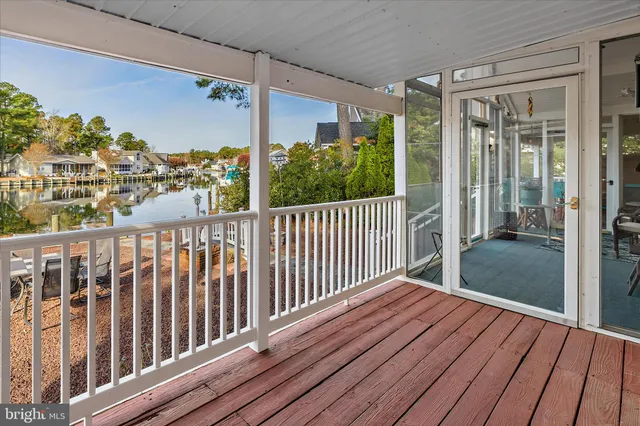 a view of a lake with a bench in front of building