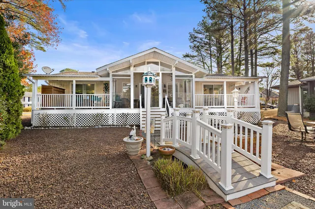 a view of a house with backyard porch and sitting area