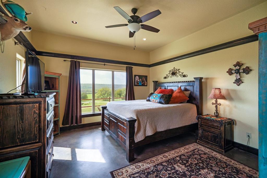 1084 Beddo Mountain Road Santo, TX 76472 - Photo 11 of 40 a bed room with a bed and a television