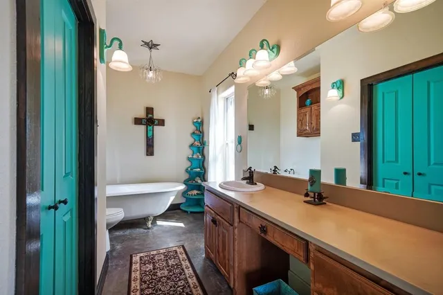 a bathroom with a sink a large mirror and a bathtub