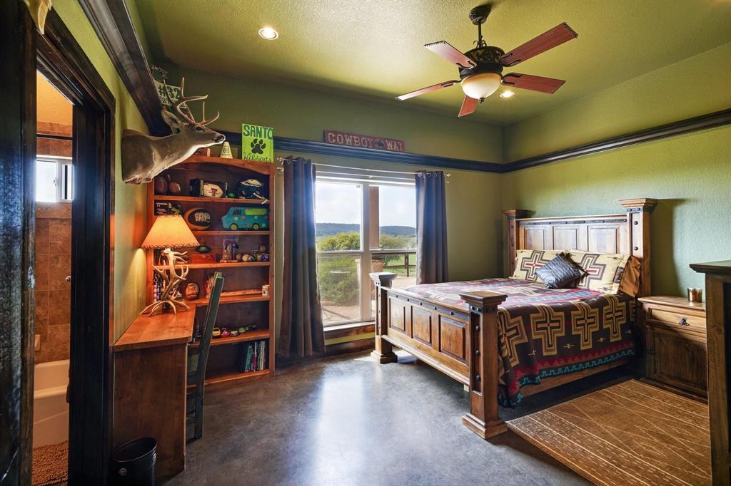 1084 Beddo Mountain Road Santo, TX 76472 - Photo 14 of 40 a bedroom with a bed and wooden floor