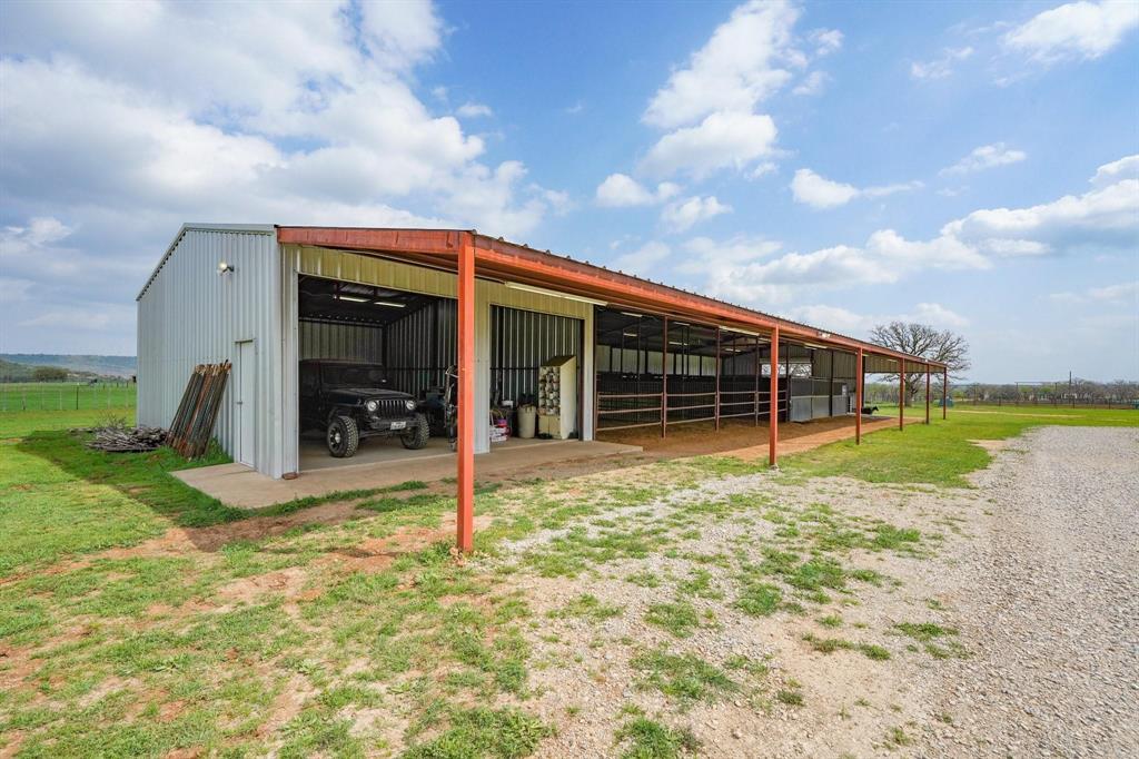 1084 Beddo Mountain Road Santo, TX 76472 - Photo 24 of 40 a view of a house with backyard and porch