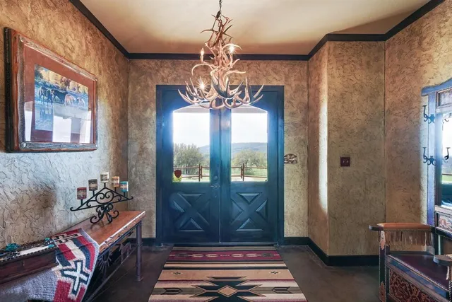 a living room with furniture and a chandelier