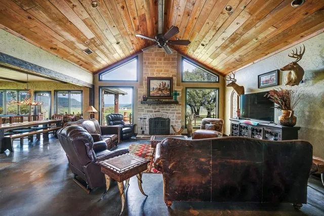 a living room with furniture a fireplace and a flat screen tv