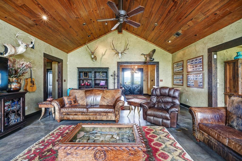 1084 Beddo Mountain Road Santo, TX 76472 - Photo 8 of 40 a living room with furniture a rug and a chandelier
