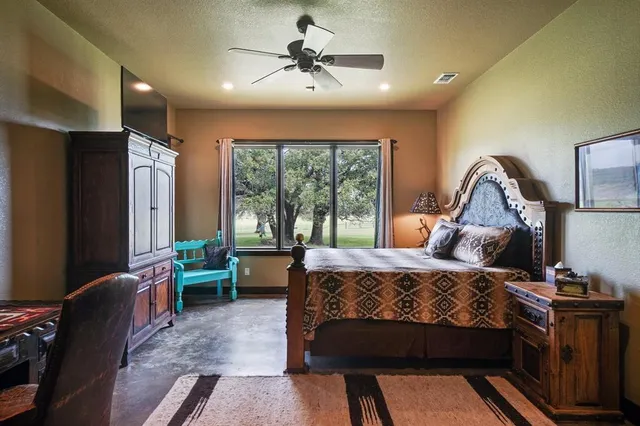 a bedroom with a bed couch and a window