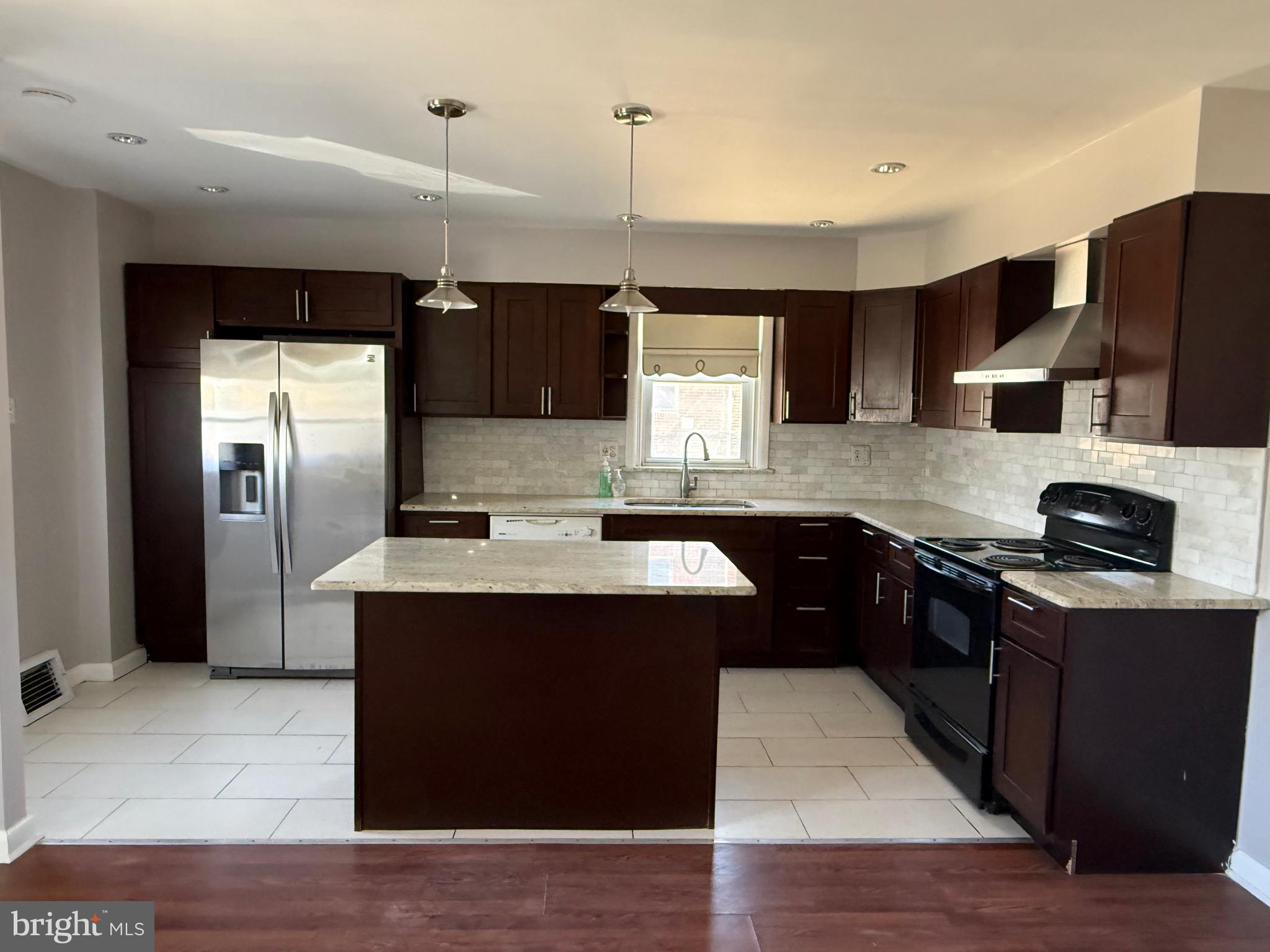 9083 Convent Avenue Philadelphia, PA 19136 - Photo 5 of 22 a kitchen with stainless steel appliances granite countertop a sink stove and refrigerator