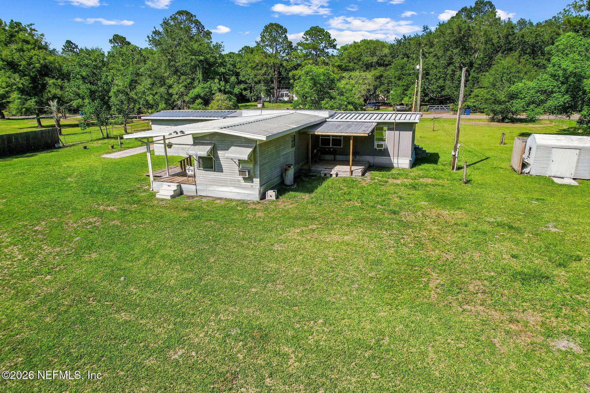 15690 Sears Road Jacksonville, FL 32218 - Photo 21 of 27 a view of a house with a big yard potted plants and large tree