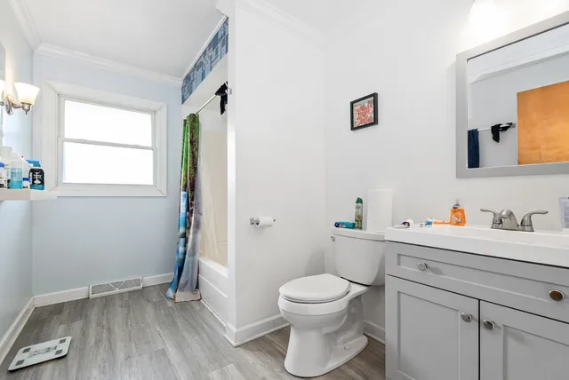 a white toilet sitting next to a bathroom sink