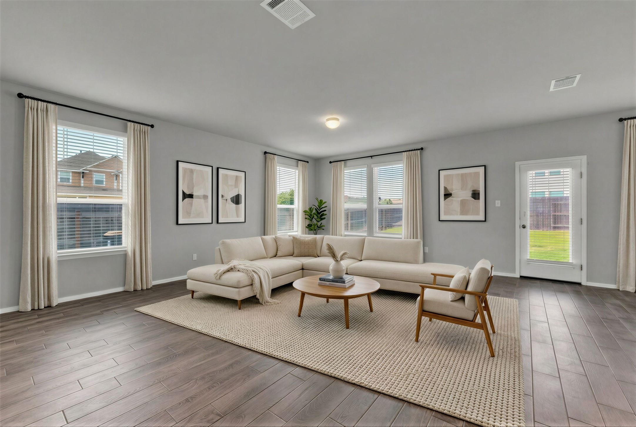101 Crescent Street Georgetown, TX 78626 - Photo 6 of 39 Virtually staged - Living area featuring rich hardwood floors complement a neutral palette in this light-filled great room.