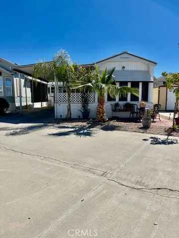 a view of house with outdoor space and sitting area