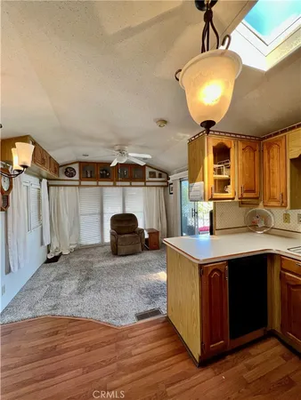 a kitchen with stainless steel appliances granite countertop a sink a stove and a wooden floors
