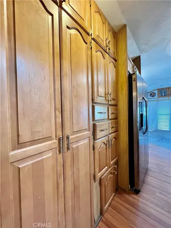 a view of a refrigerator in kitchen and wooden floor