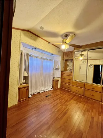a view of a room with wooden floor and furniture