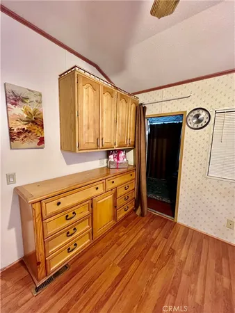 a kitchen with granite countertop a stove and a wooden floors