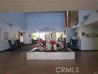 a living room with furniture a window and a dining table