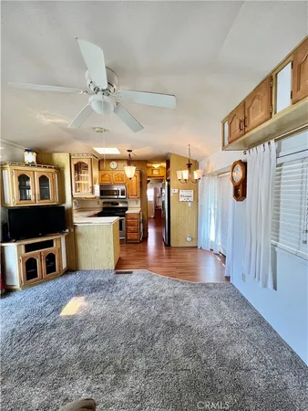 a view of a kitchen with refrigerator and a stove top oven
