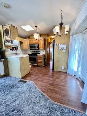 a kitchen with stainless steel appliances granite countertop a sink and a refrigerator