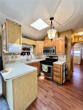 a kitchen with wooden floors and wooden cabinets