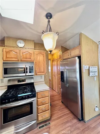 a kitchen with stainless steel appliances granite countertop a stove and a refrigerator