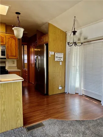 a view of a room with wooden floor and a window