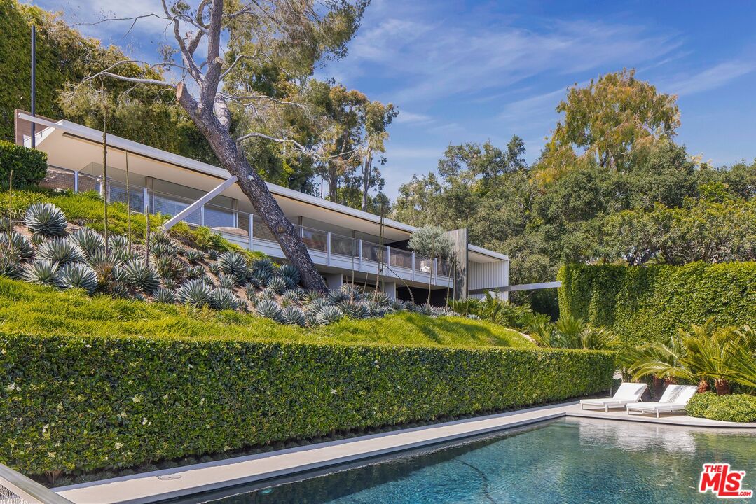 10801 Chalon Road Los Angeles, CA 90077 - Photo 1 of 1 a view of a garden with a house