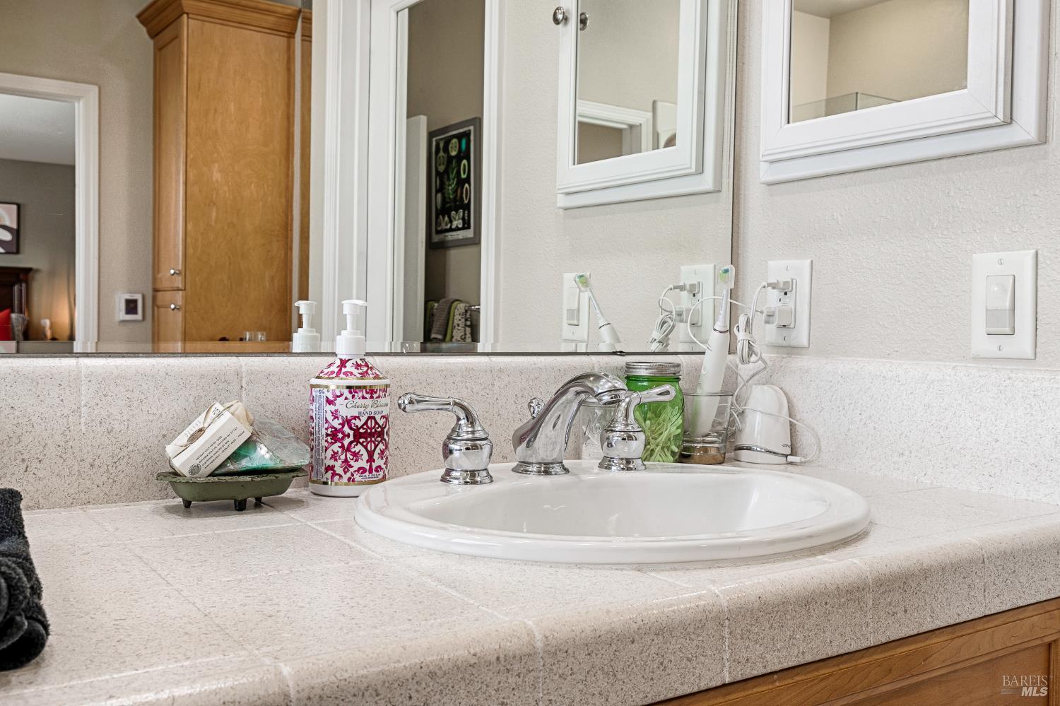 2167 Linwood Avenue Santa Rosa, CA 95404 - Photo 58 of 80 a bathroom with a granite countertop sink and a mirror