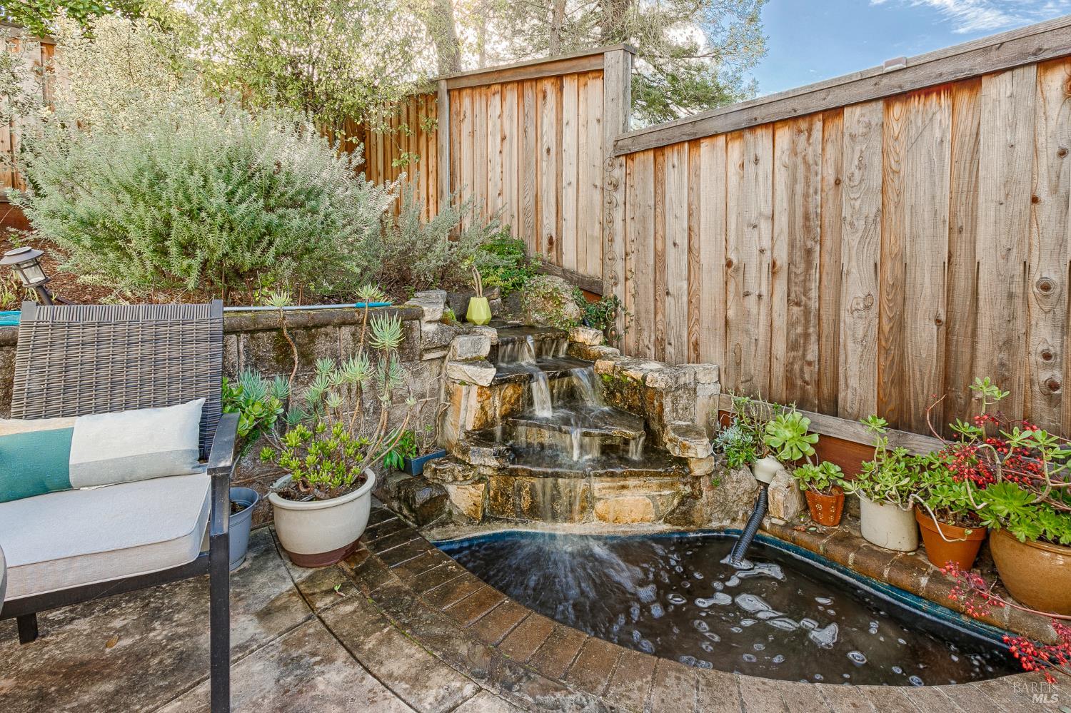 2167 Linwood Avenue Santa Rosa, CA 95404 - Photo 77 of 80 a view of a backyard with chair and potted plants