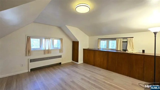 a view of room with window and wooden floor